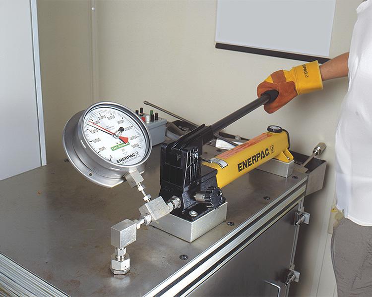 An enerpac handpump connected to a large machine to pump hydraulic fluid around.